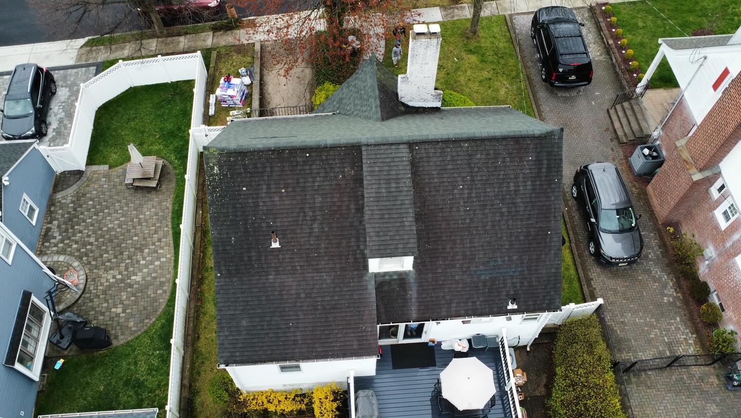 Overhead drone view of a Maywood NJ home with an aging dark shingle roof before replacement